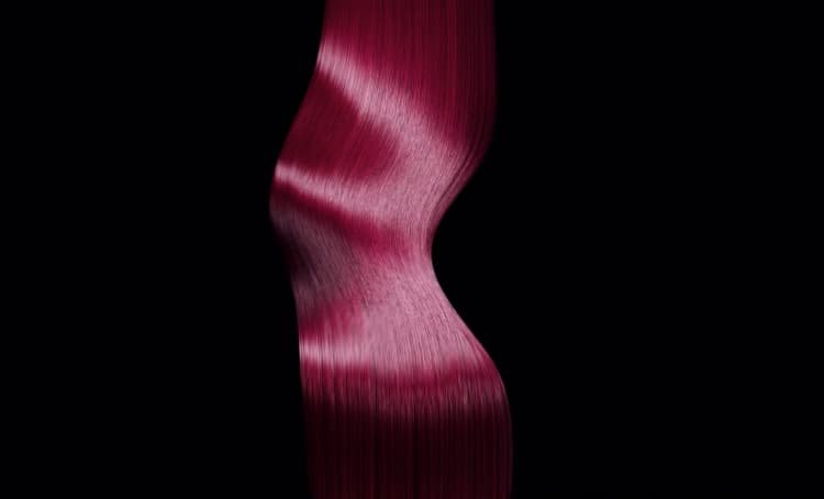 Image of vibrant pink-dyed long hair, illustrating expert tips on how to care for colored hair and maintain its health and vibrancy